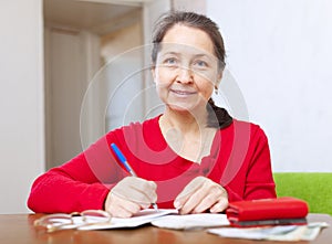 Woman is calculated the family budget photo