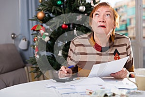 Woman calculates utility costs in the new year