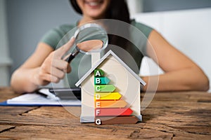 Woman Calculating Energy Efficient House