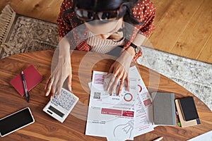 Woman calculating financial bill at home
