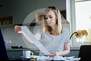 Woman calculating payment bill at home