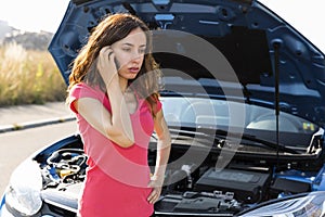 Woman caling autoservice because of car problem