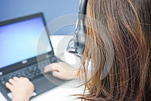 Woman callcenter with headset on job