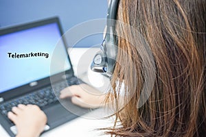 Woman callcenter with headset on job with laptop