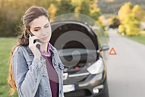 Woman calling car assistance