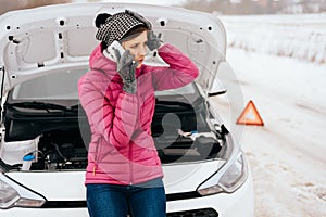 Woman calling for help or assistance - winter car breakdown
