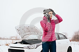 Woman calling for help or assistance - winter car breakdown photo