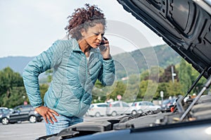 Woman calling mechanic service after vehicle problem