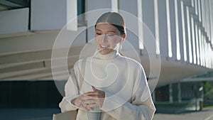 Woman calling phone headphones walking outdoors close up. Lady talking headset.