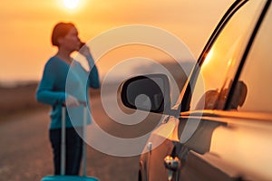 Woman calling roadside assistance after her car broke down