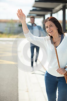 woman calling taxi arriving at airport