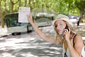 woman calling taxi with map in hands