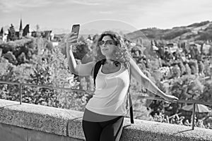 Woman calling for video call in touristic place photo