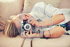 Woman, camera and couch for retro, photography and fashion in casual outfit for hobby at home. Analog, lens or female