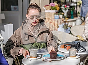 Woman with camera in outdoor cafe. Barcelona, Catalonia.