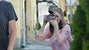 Woman with camera taking photo of famous actors couple street, spying paparazzi