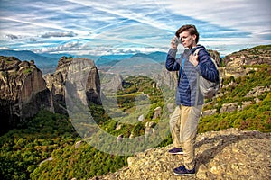 Woman with camera on top of mountain