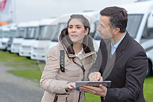 Woman with campervan salesman