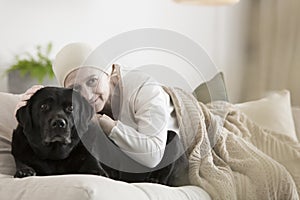 Woman with cancer hugging dog