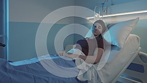 Woman with cancer sleeping in a hospital bed