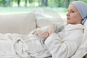 Woman with cancer on sofa