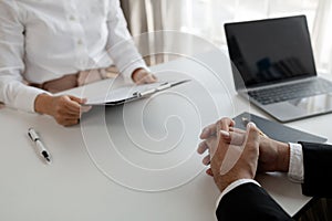 Woman candidate interview with HR manager in office, Examiner reading a resume during job interview at office Business and human