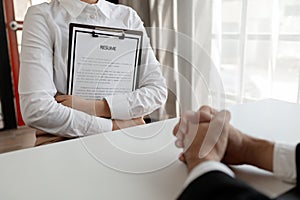 Woman candidate interview with HR manager in office, Examiner reading a resume during job interview at office Business and human