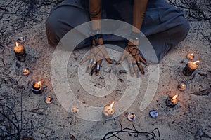 Woman with candle deep in forest. Witch craft