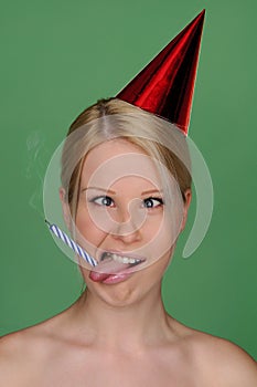 Woman with candle extinguished and festive cap