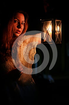 Woman candle lamp dark night