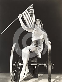Woman on cannon holding American flag