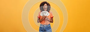 Woman cannot hide happiness winning lottery. Portrait of surprised and happy lucky African American young woman with