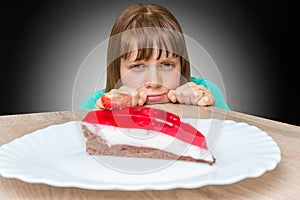 Woman cannot resist the temptation and wants to eat sweet cake