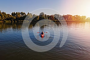 Woman in a canoe crossing the small river