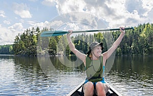 Woman canoeing on the lake with dog