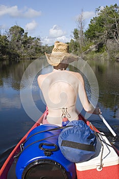 Woman canoing from behind portrait