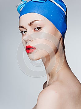 Woman in cap and goggles for swimming naked shoulders model portrait side view