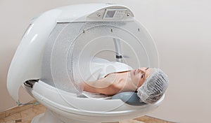 Woman in capsule at spa salon