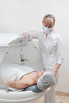 Woman in capsule at spa salon