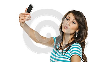 Woman capturing photo of herself on cellphone