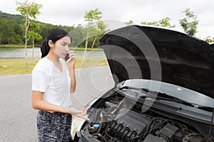 Woman after a car breakdown at the side of the road