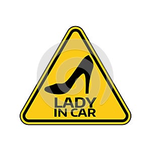 Woman car driver sticker. Female in automobile warning sign. Lady shoe with a heel in yellow triangle to vehicle glass.