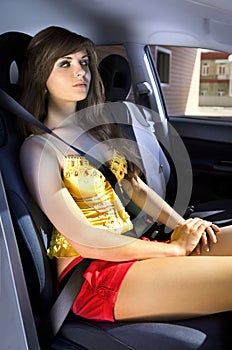 Woman in car fastened by seat belt photo