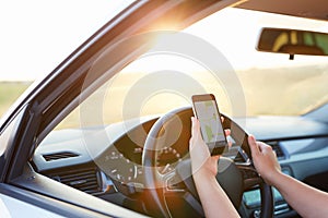 Woman in the car and holding mobile with map gps navigation