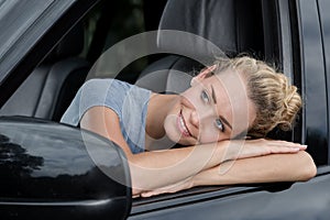 Woman in car leaning out windows