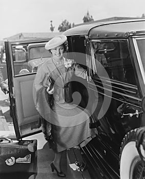 Woman with car and luggage