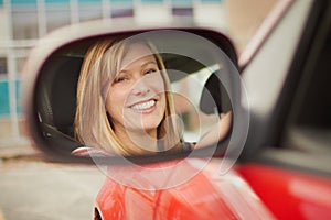 Woman in car mirror
