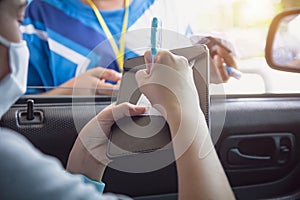 Woman in car paying gasoline with credit card, female holding debit card payment at gas station. Petrol oil loyalty mileage point