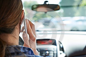 Woman In Car Talking On Mobile Phone Whilst Driving