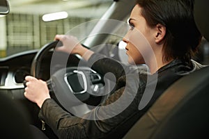 Woman, car and thinking while driving for a roadtrip journey in a luxury vehicle. Female person, back and steering wheel